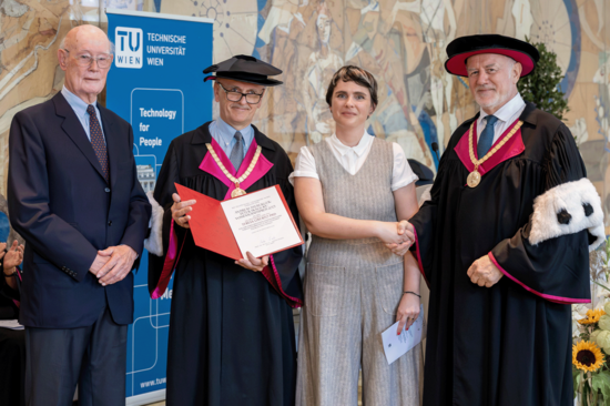 4 persons, left: Herbert Hochegger with suit, center left Vice Rector Fröhlich in regalia, center right Teresa Liberto in cream ensemble, top V-neck, right Vice Rector Eberhardsteiner in regalia.
