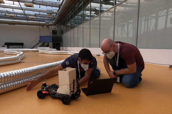 two people with a model car