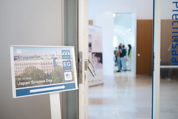 Bright entrance area. In front of it a sign for the Japanese Science Day