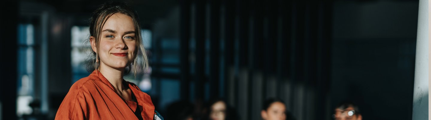 a woman standing on stage with a blurred background