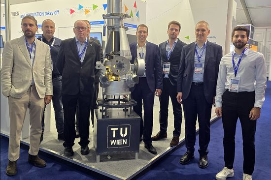 Group photo with several men at the booth.