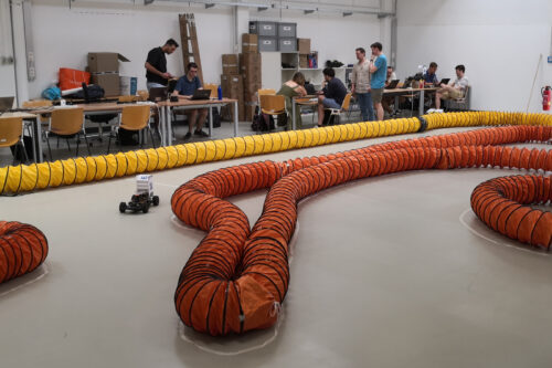 Students working on the cars at the race track